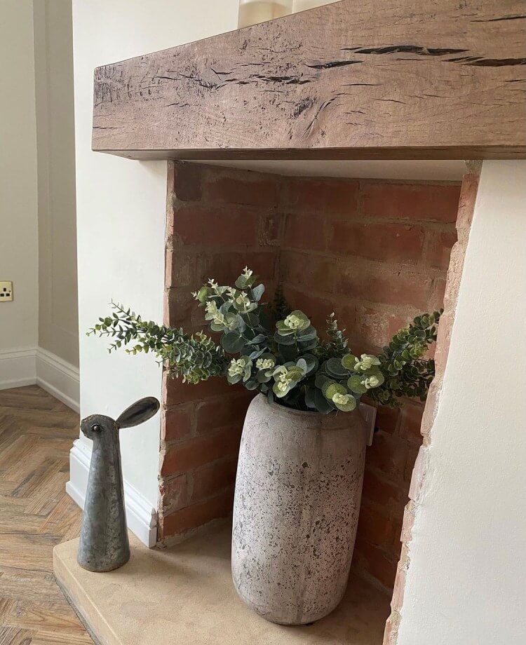 Chunky wooden mantel beam on wall