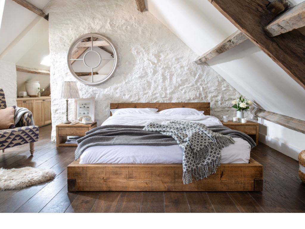 minimalist bedroom furniture with curved corners and slatted headboard against a tongue and groove wall in a room with wooden floors